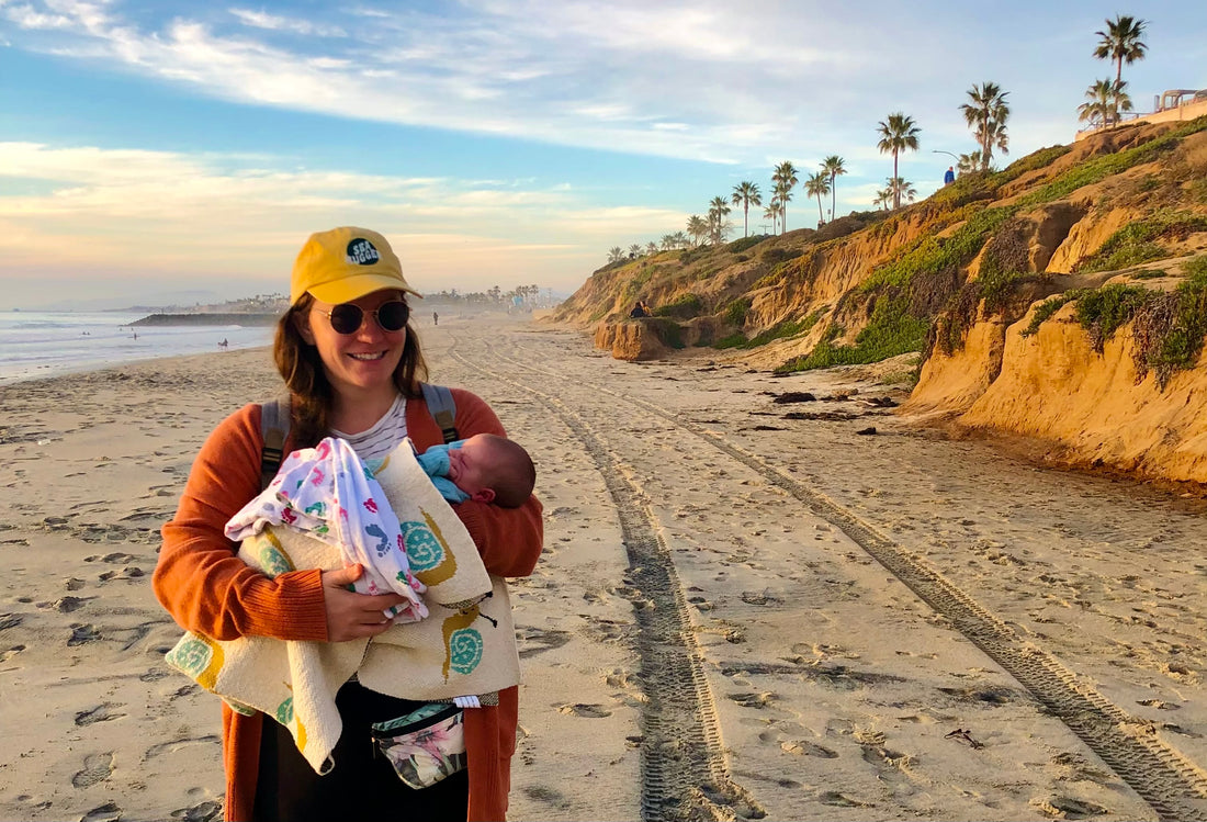 Aubry Casey from Sea Hugger at the beach with her baby